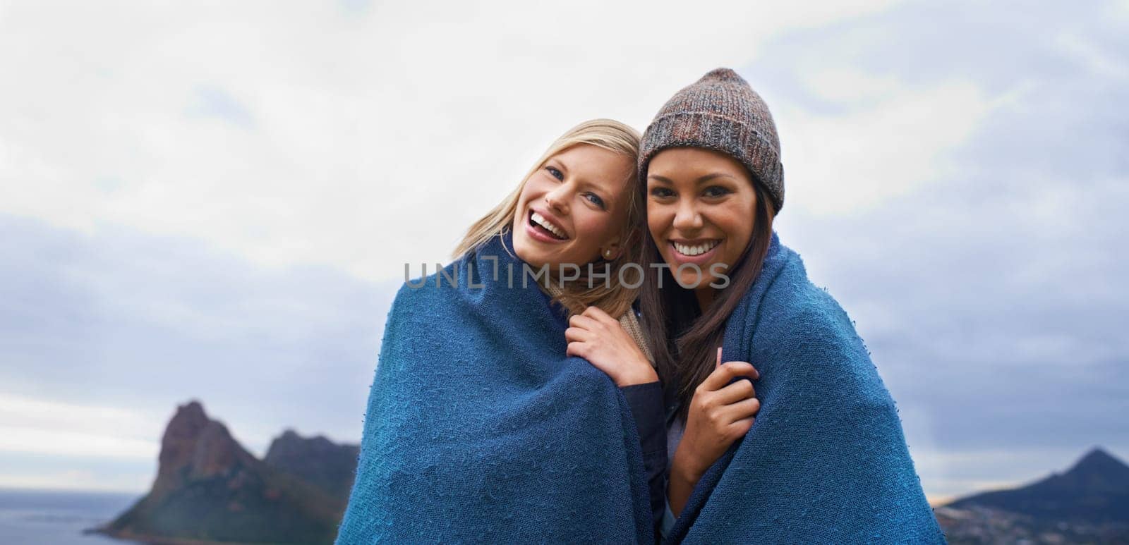 Friends, mountain and portrait of women with blanket in winter for adventure on holiday, vacation and weekend. Nature, travel and person by seaside for relaxing, happiness or bonding in countryside.