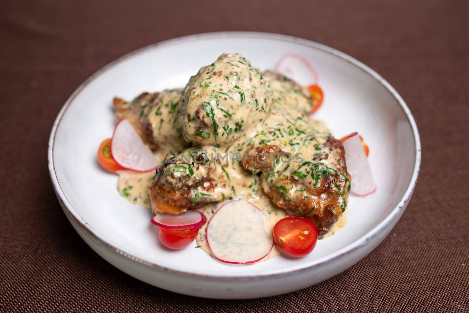 Juicy Chicken Fricassee with Creamy White Sauce and Fresh Vegetables on Plate by Pukhovskiy