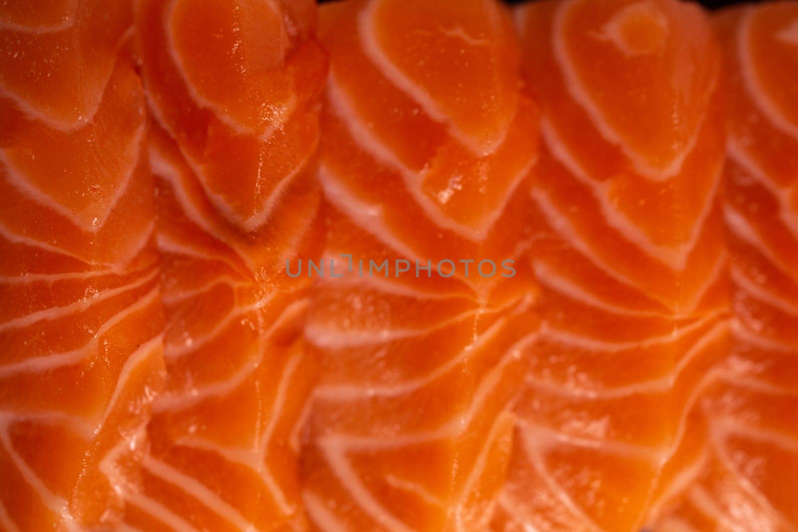 Close-up view of a fresh raw salmon fillet with delicate flavor and pink color on a white background by Pukhovskiy