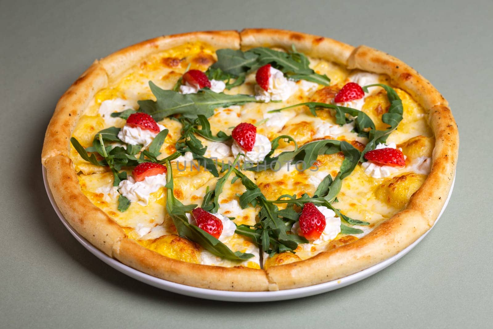 Freshly Baked Pizza with Strawberries, Cream Cheese, and Arugula on White Plate - Summer Party Theme by Pukhovskiy