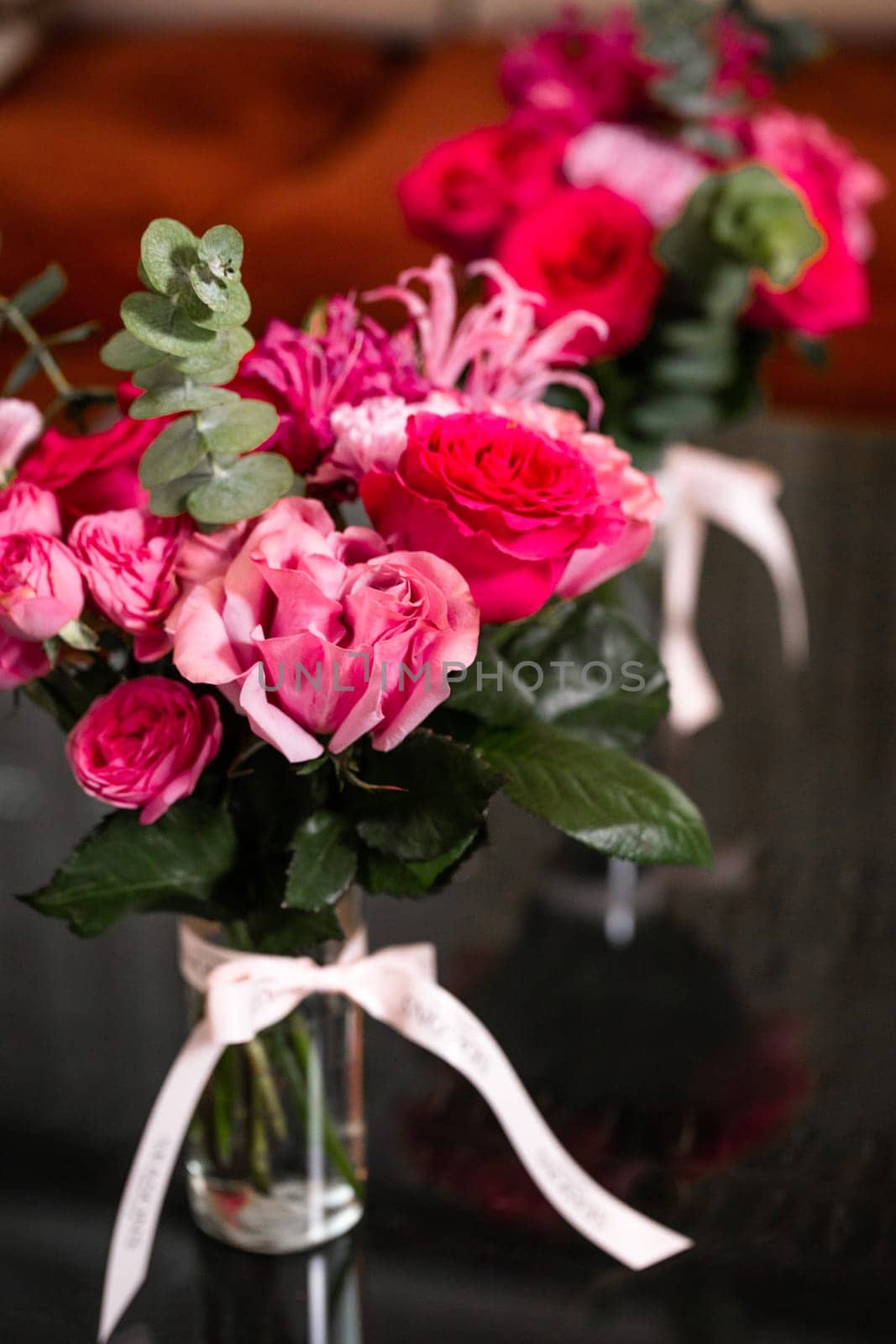 Vibrant Pink and Red Roses in Glass Vase on Black Background, Ideal for Valentines or Mothers Day by Pukhovskiy