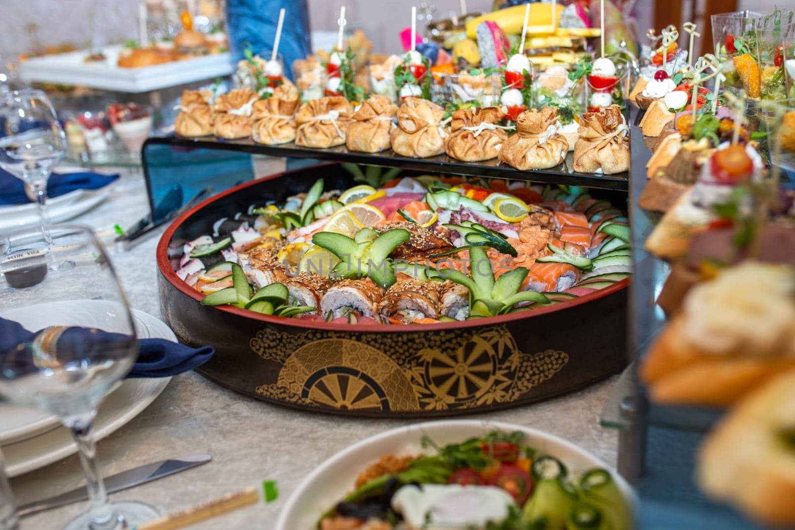 A buffet in a chic hotel with seafood, sushi, salads, fruits and pastries.