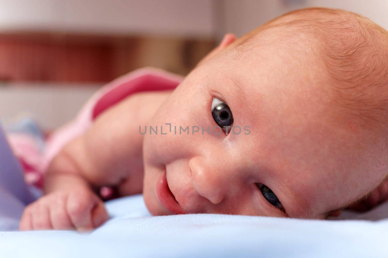 Curiosity of a two-month-old baby, as they gaze gently into the lens for a heartwarming portrait.