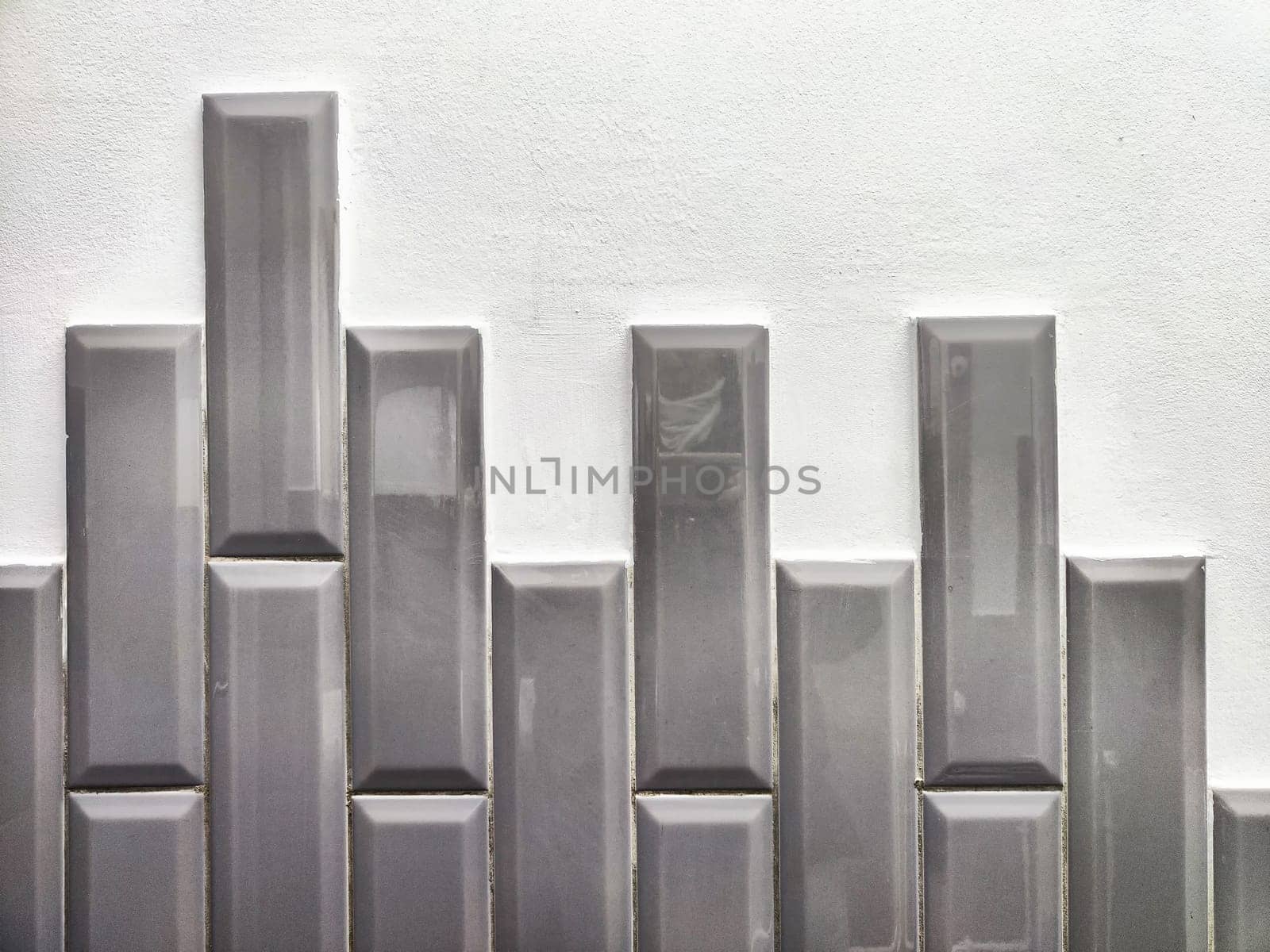 The texture is uneven teeth of gray new brick. The texture of stone wall. A piece of abstract brickwork