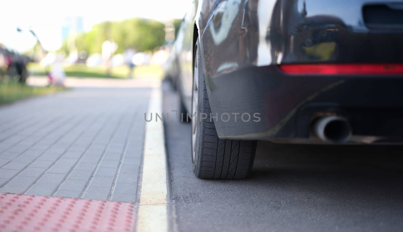 Car is parked near yellow median strip closeup by kuprevich