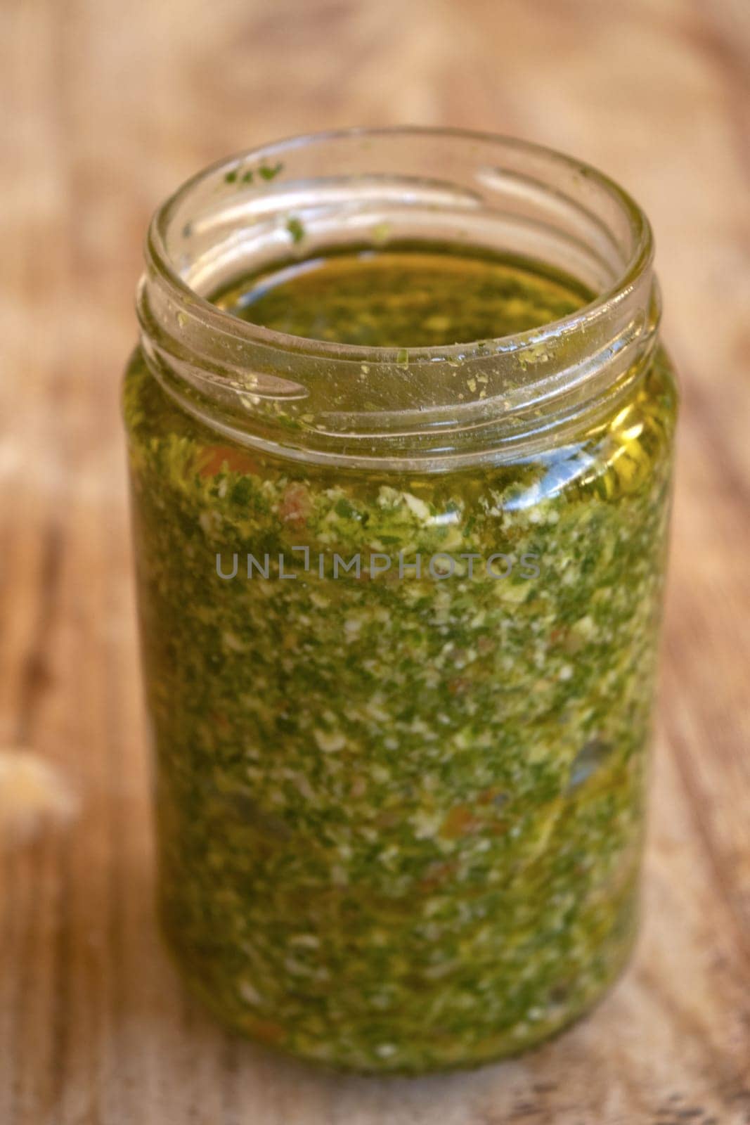 fresh homemade basil pesto placed in a glass jar