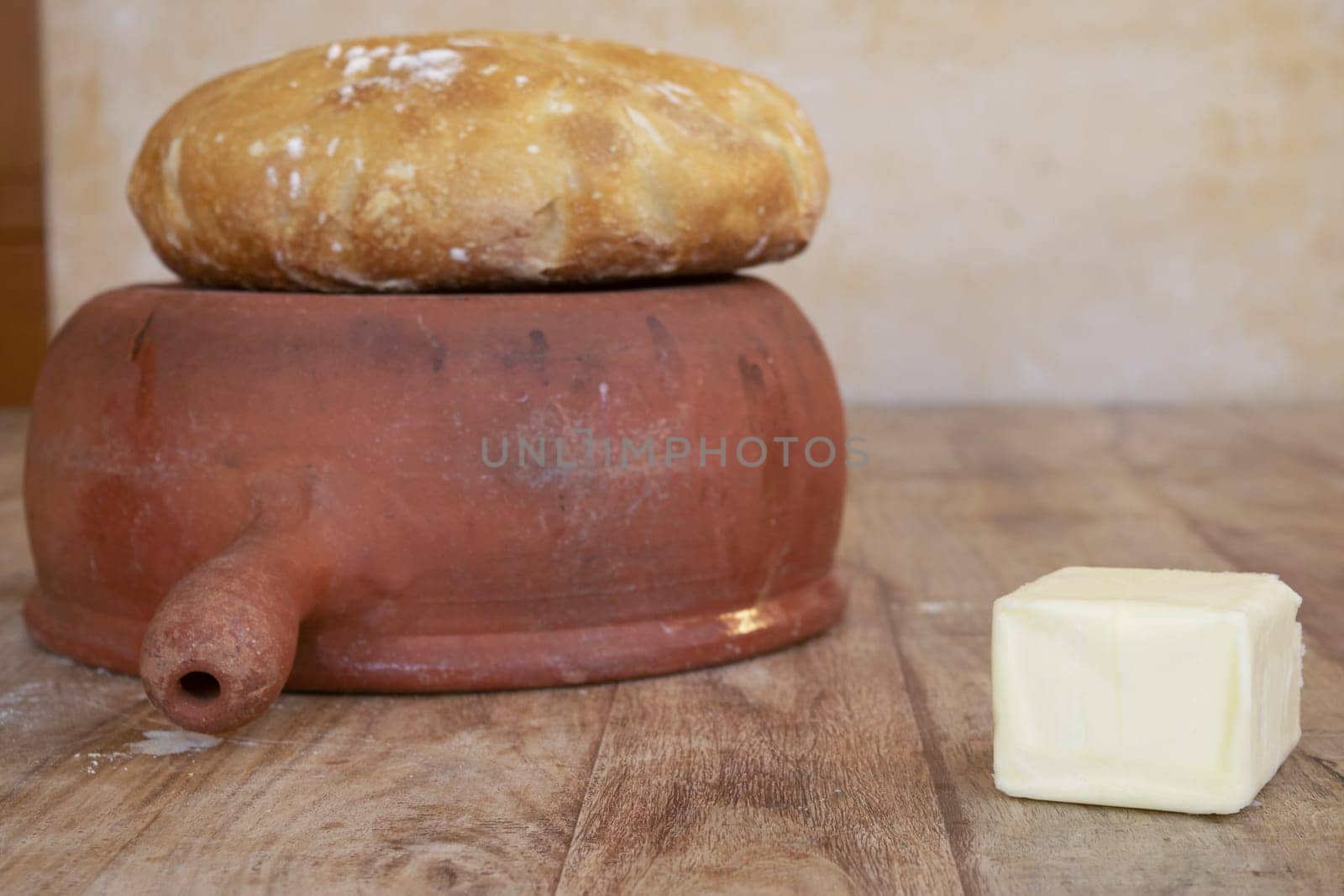 homemade bread loaf and a piece of butter