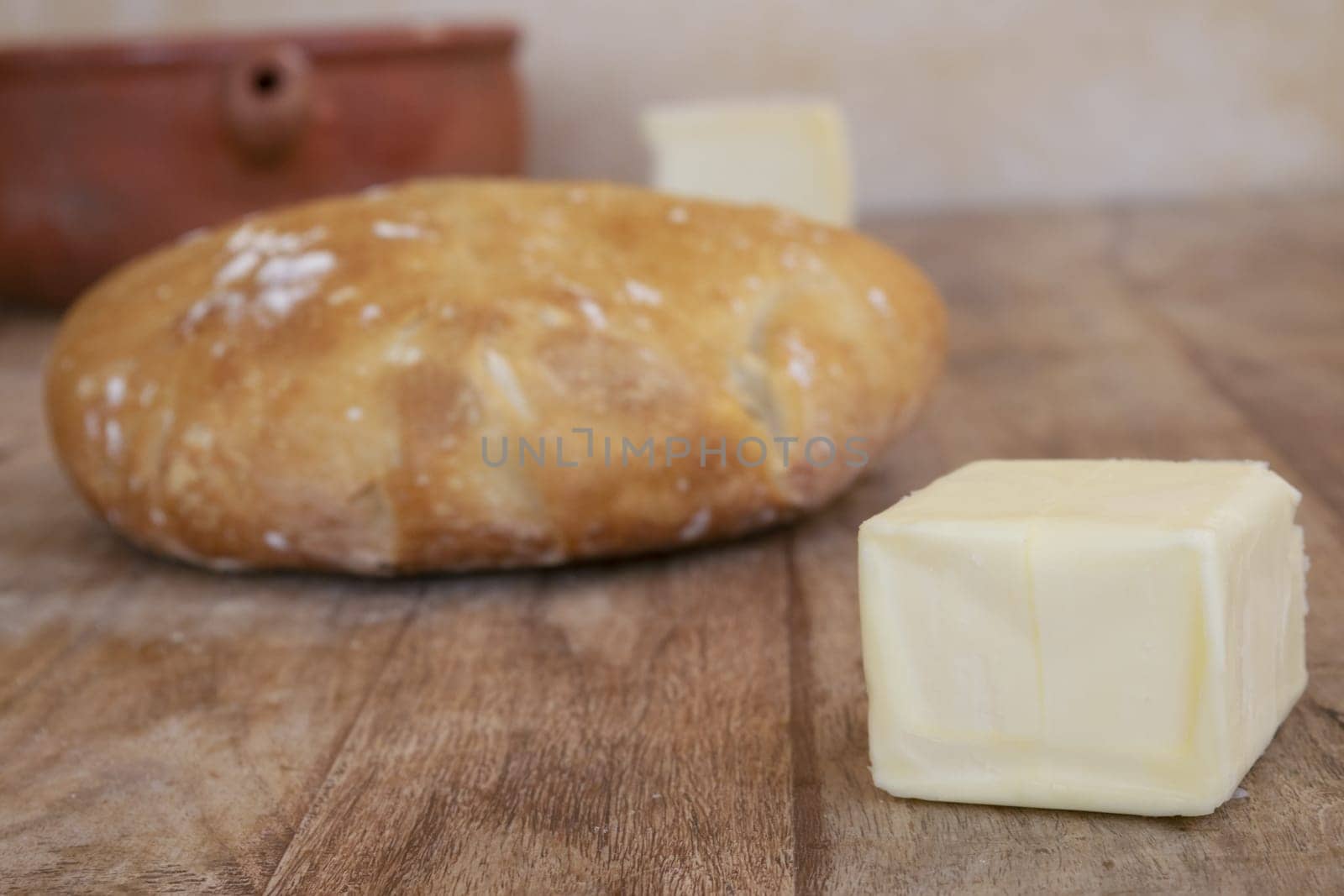 homemade bread loaf and a piece of butter