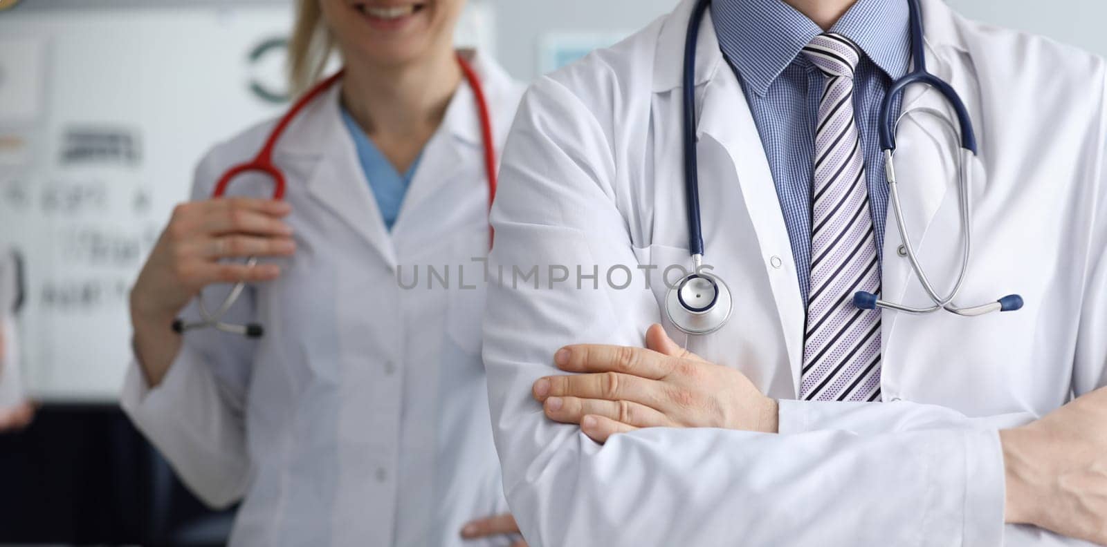 Doctors man and woman ready to examine patient. High-quality daily work clinic. Round-the-clock front desk. Clinic emergency call. Online doctor consultation. Patient health insurance