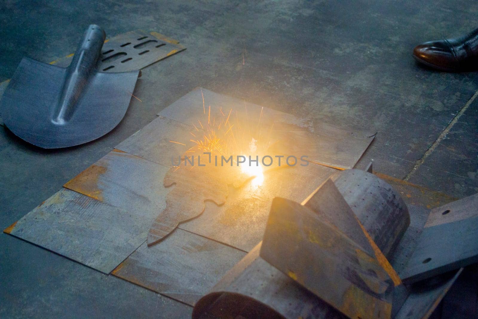 Laser cleaning of metal. The laser beam cleans the metal surface from rust. by Mari1408