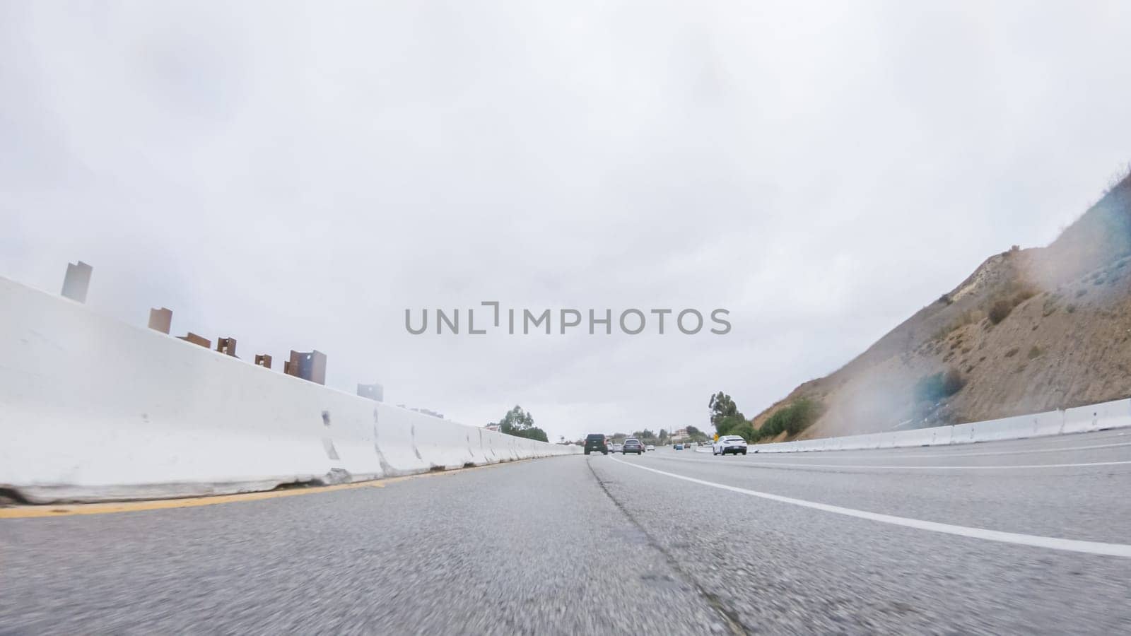 Amidst a rainy winter day, driving on HWY 134 near Los Angeles, California, captures the atmosphere through raindrop-covered lenses, adding a unique and moody perspective to the journey.