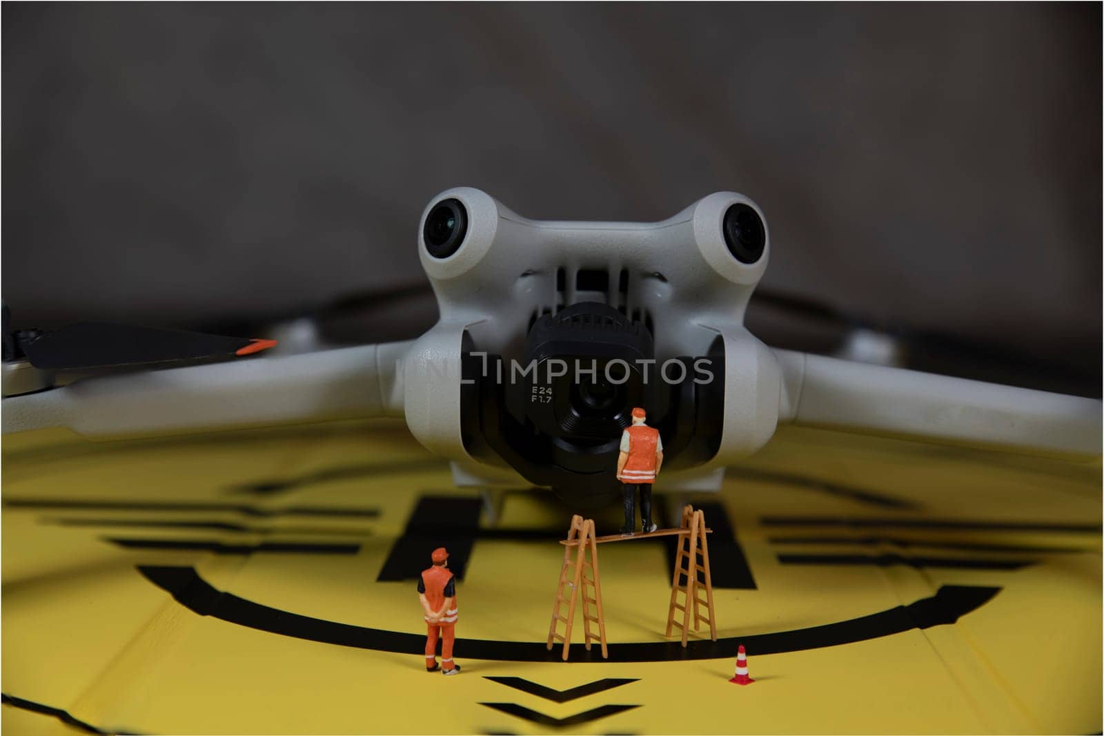 miniature figures checking the working of the drone by compuinfoto