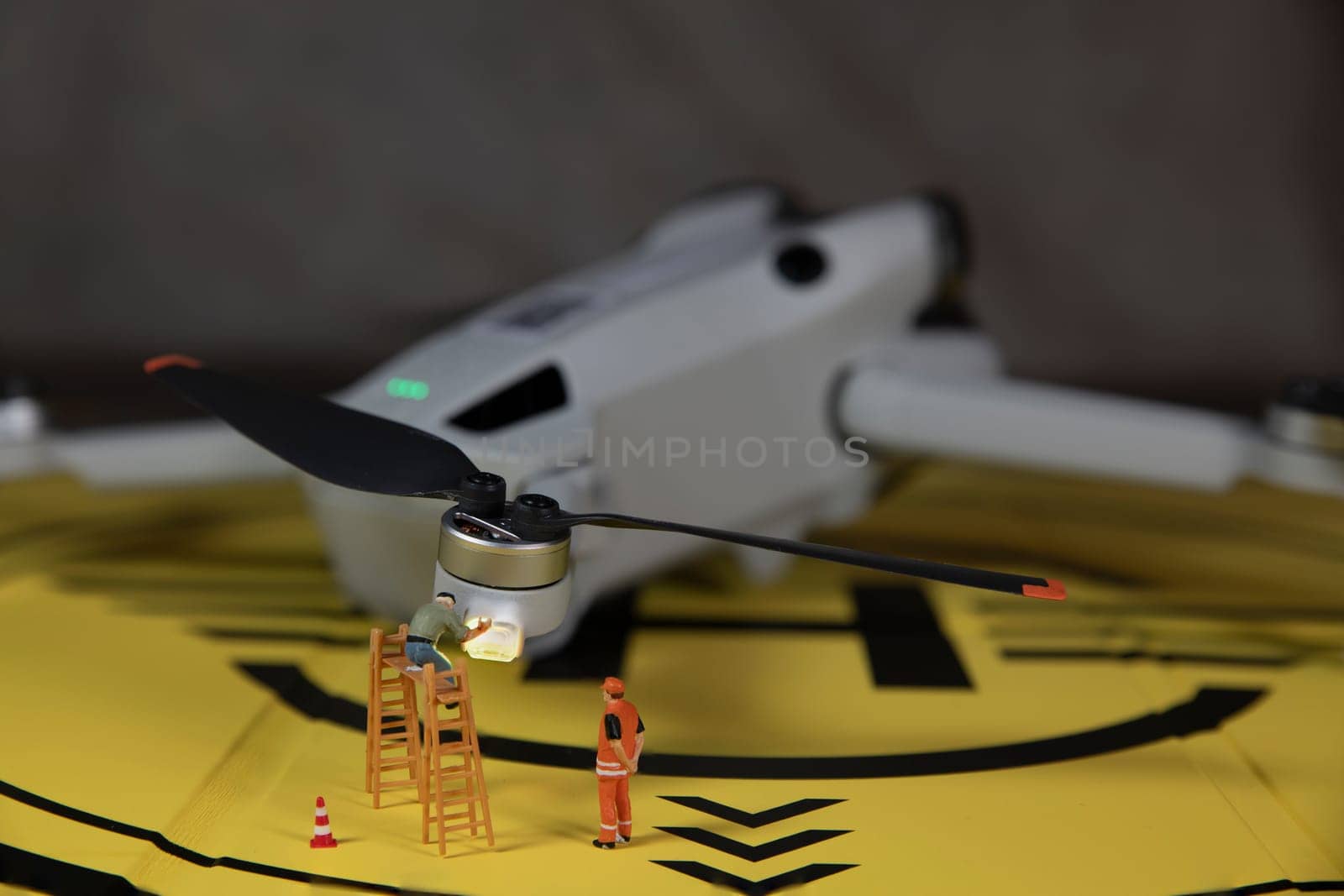 miniature figures checking the working of the drone lights by compuinfoto