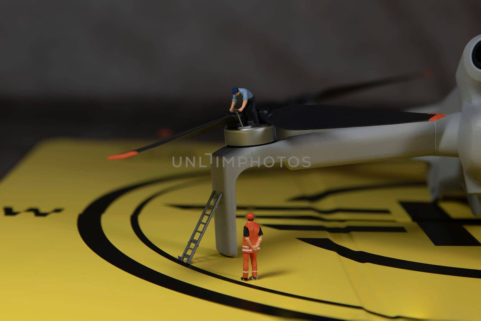 miniature figures checking the working of the drone propeller by compuinfoto