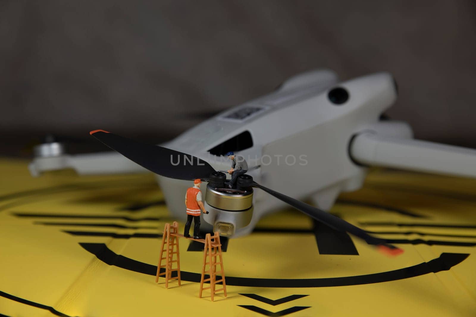 miniature figures checking the working of the drone propeller by compuinfoto
