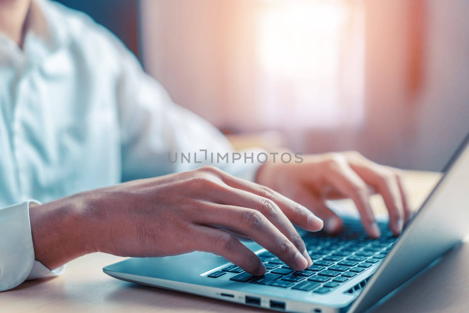 Businessman hand typing on computer keyboard of a laptop computer in office. Business and finance concept. uds