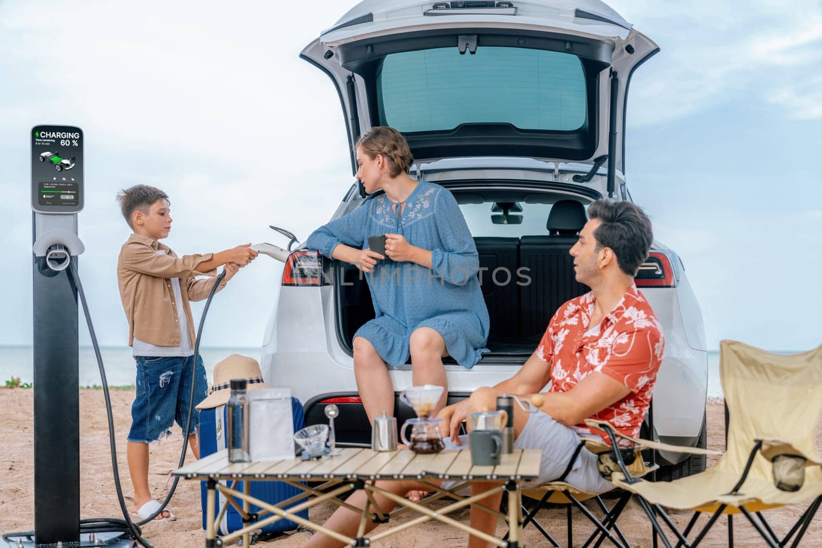 Family vacation trip traveling by the beach with electric car, happy family recharge EV car, enjoying outdoor camping coffee. Seascape travel and eco-friendly car for clean environment. Perpetual