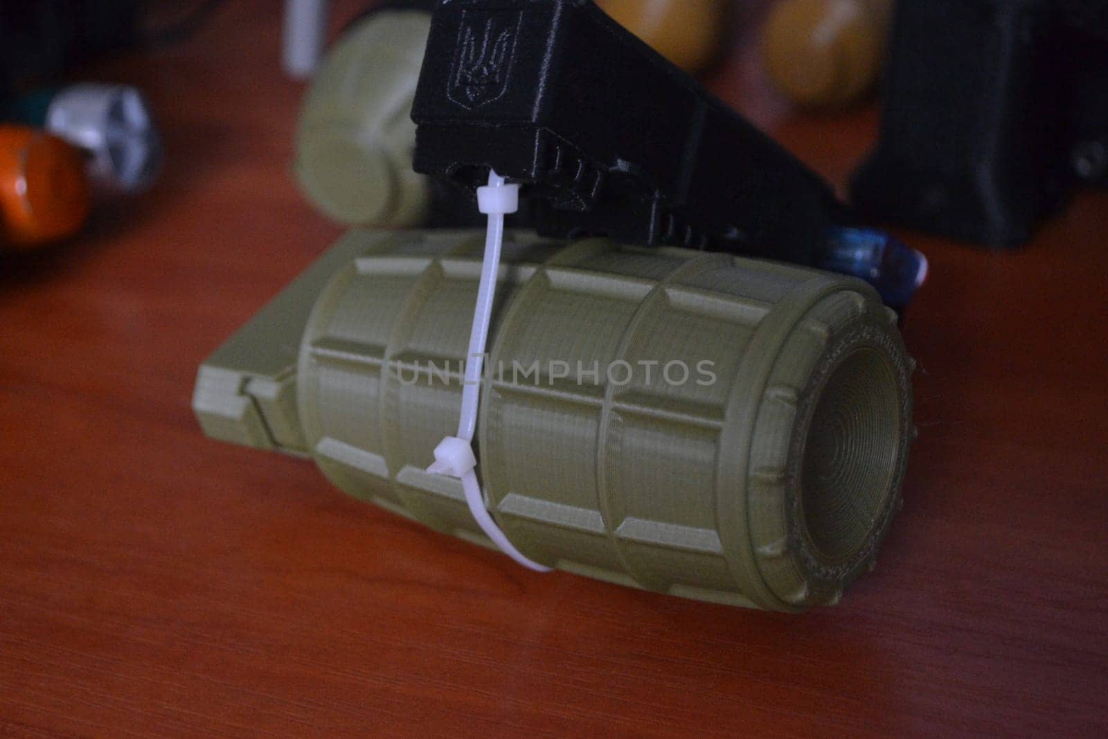 Prototype model of grenade ammunition printed on 3D printer. Small models of grenade defensive weapon printed on 3D printer from molten plastic on table. New modern innovation printing technology