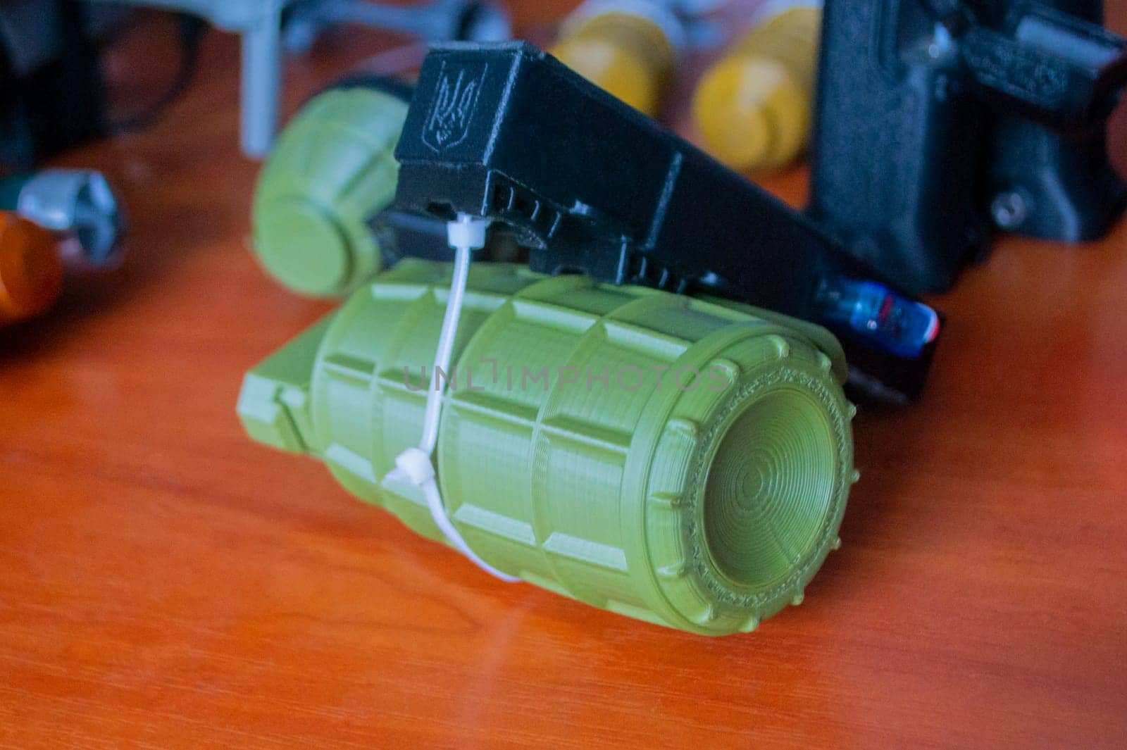 Prototype model of grenade ammunition printed on 3D printer. Small models of grenade defensive weapon printed on 3D printer from molten plastic on table. New modern innovation printing technology