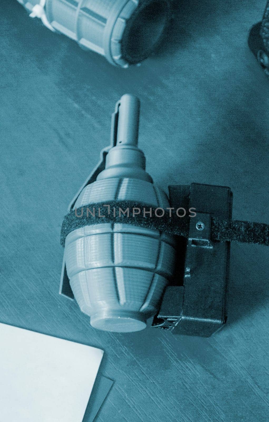 Prototype model of grenade ammunition printed on 3D printer. Small models of grenade defensive weapon printed on 3D printer from molten plastic on table. New modern innovation printing technology