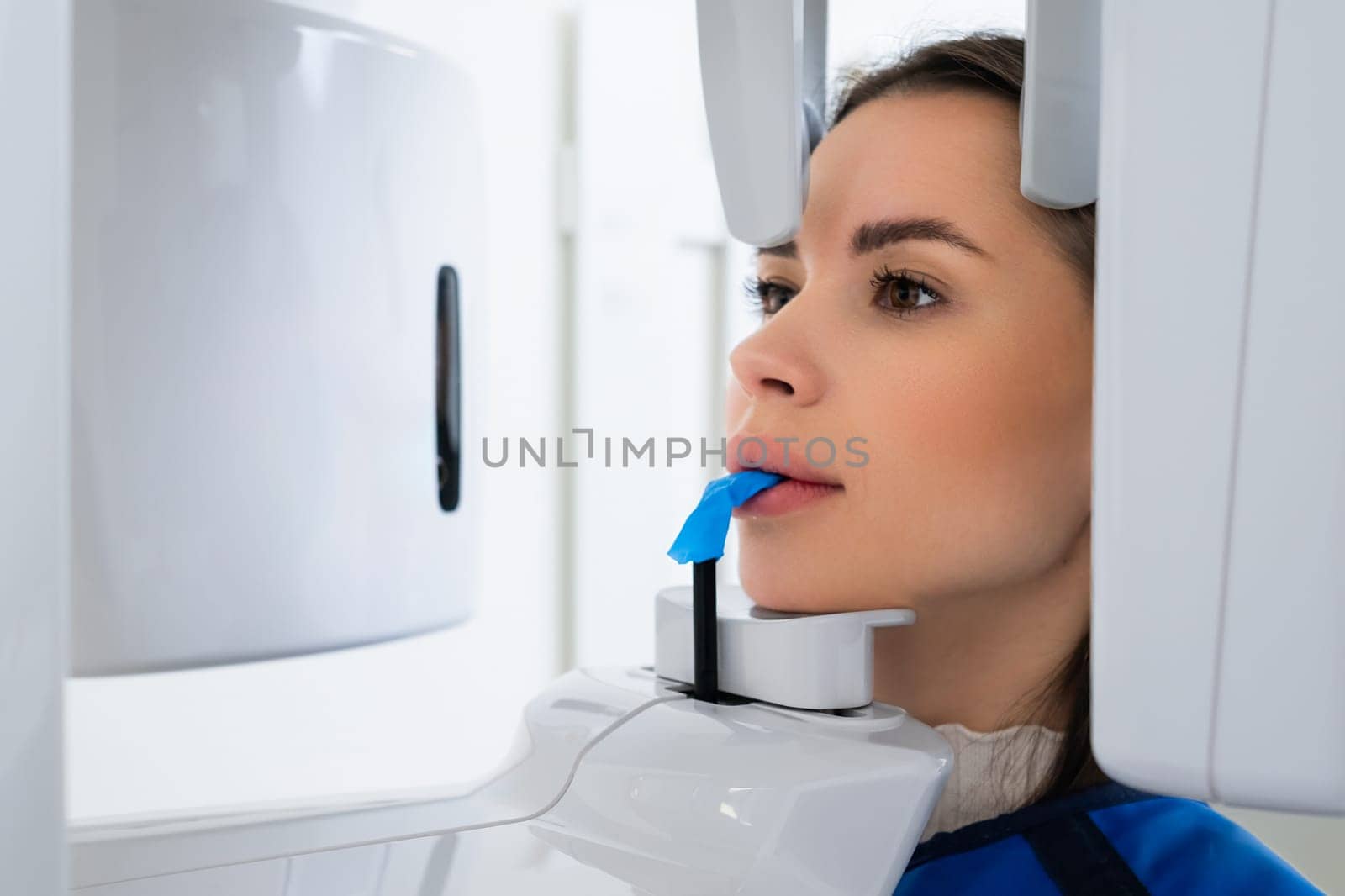 Close Up of Young Woman Receiving Panoramic Teeth X-Ray in Dentists Office.