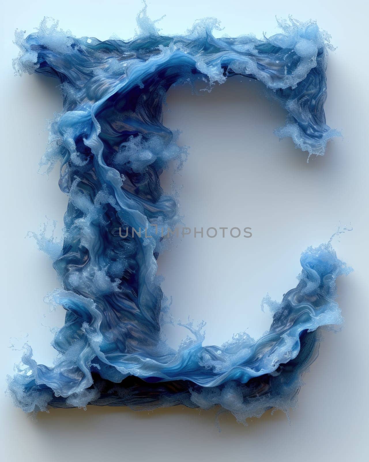 A letter crafted from blue yarn rests on a plain white surface.