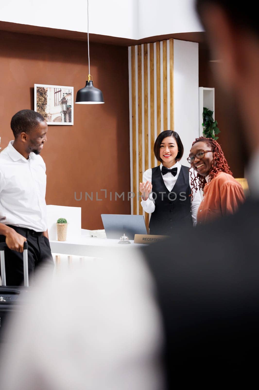 Receptionist calling for bellboy to help by DCStudio