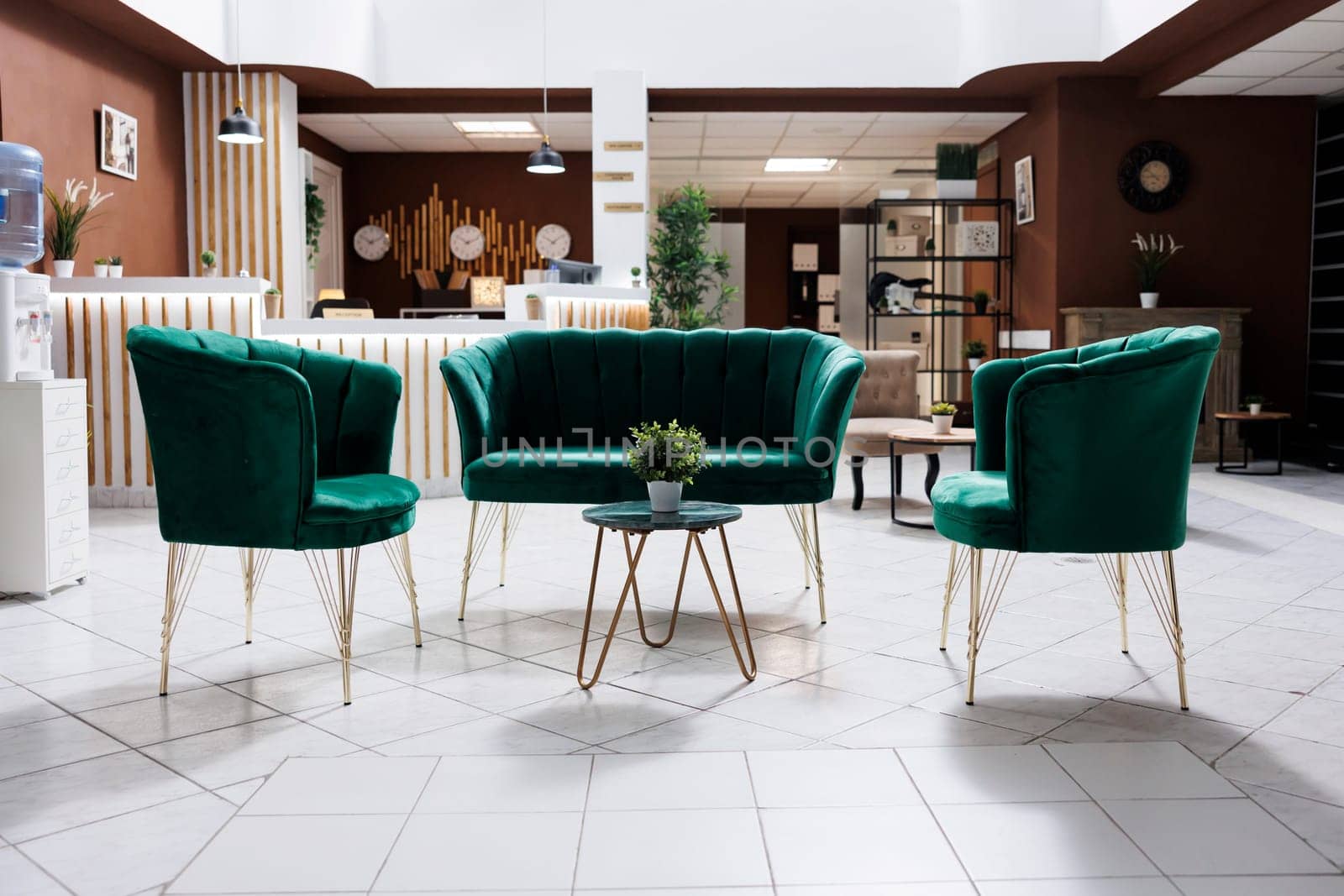 Empty lounge area in hotel lobby with modern furniture and marble floors used to welcome guests and do accommodation check in. Spacious luxury resort entrance with expensive rooms.