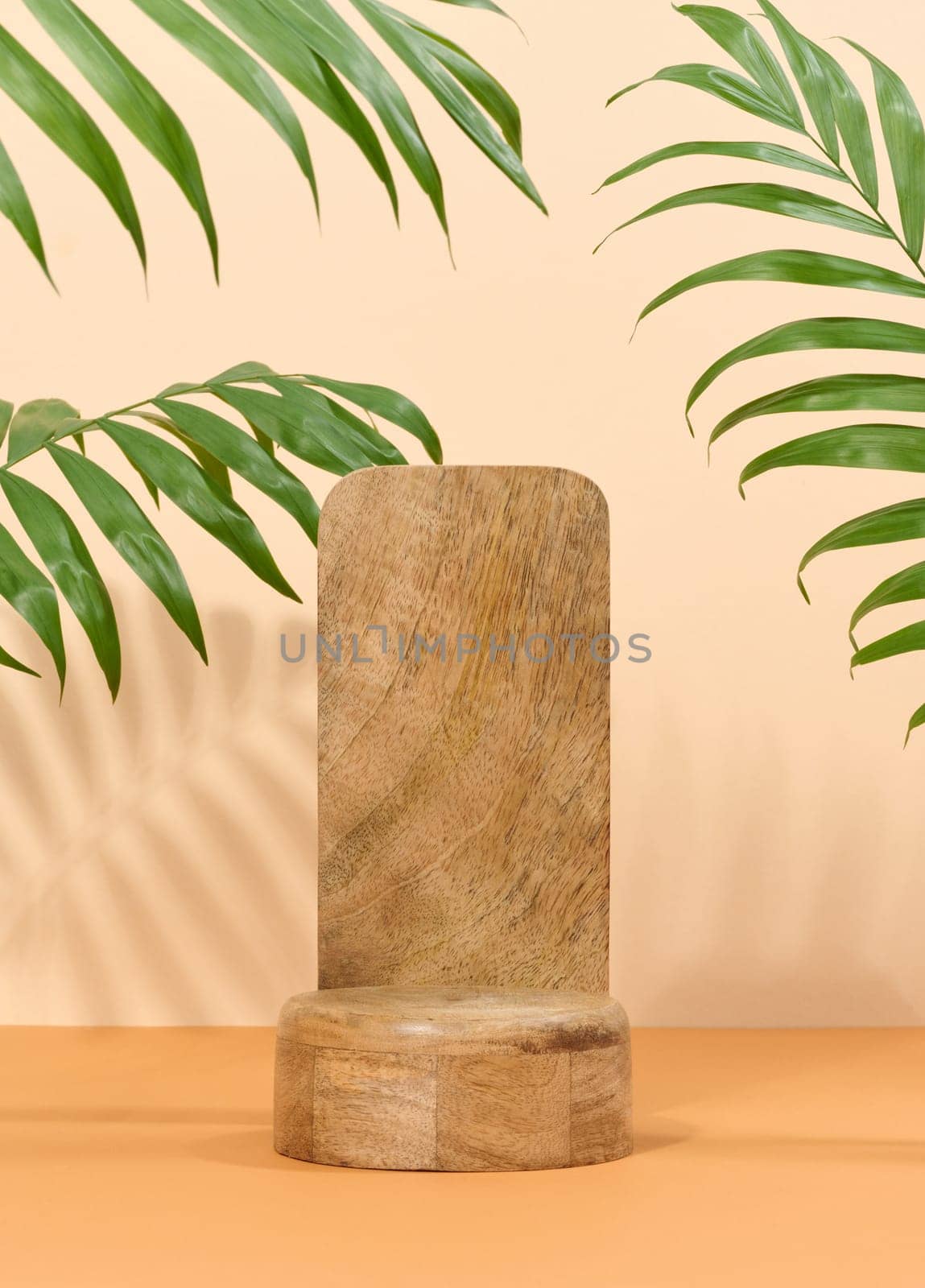 Round brown wooden stand on a white background, a place to display cosmetics and products