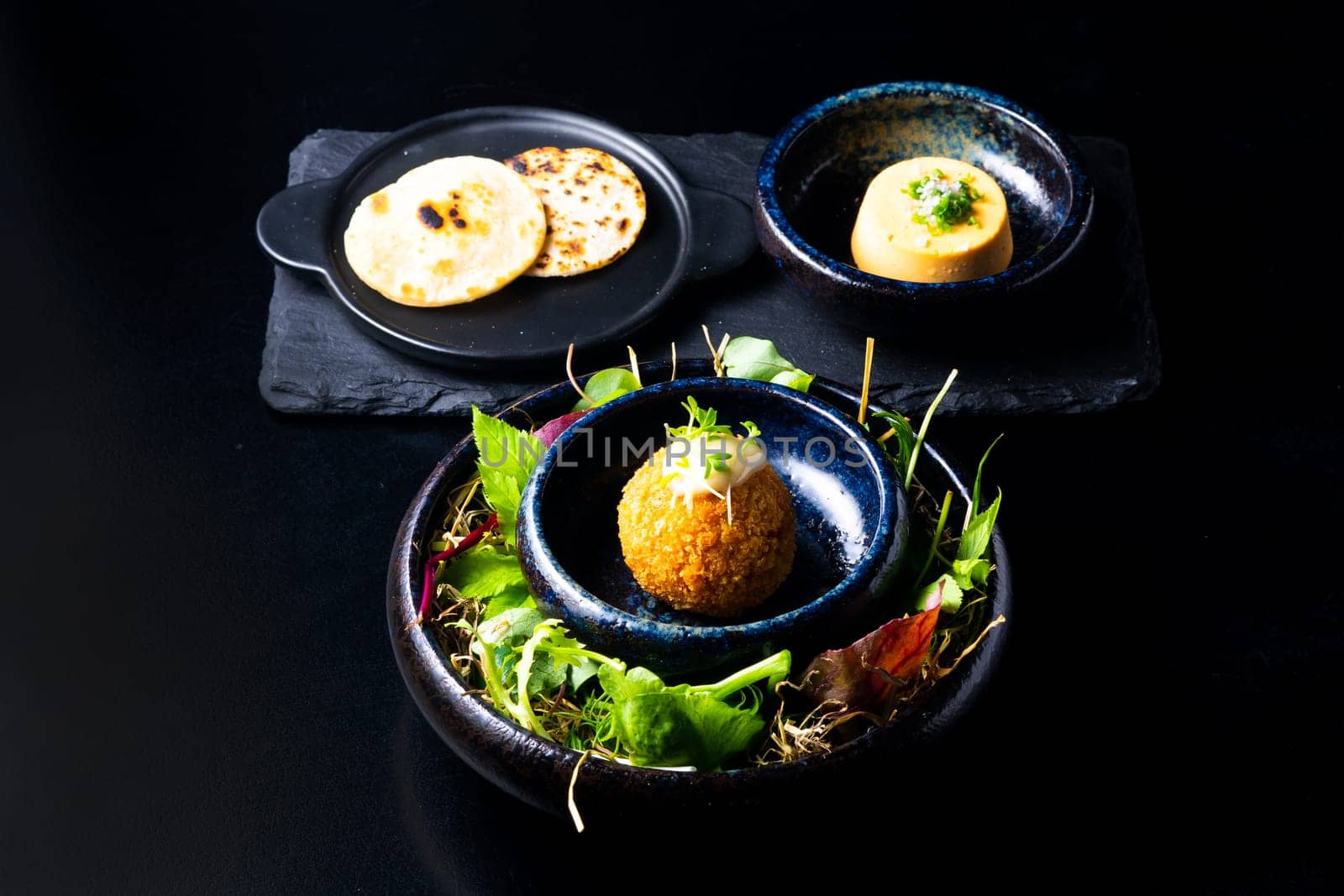 Closeup of some spanish croquettes in a bed of lettuce served as tapas by Zelenin