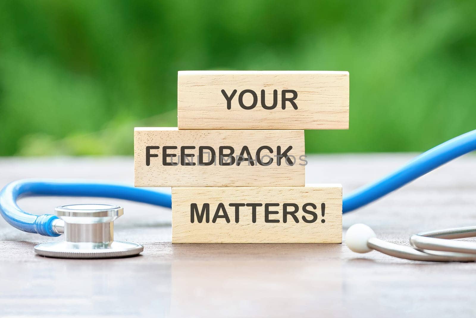 YOUR FEEDBACK MATTERS text on wooden blocks on a green background
