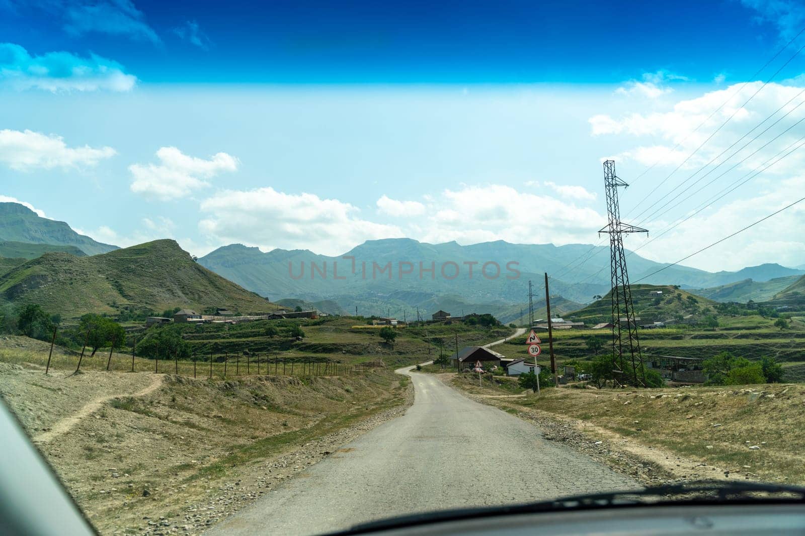 View from the car of an asphalt road in the mountainous area of Dagestan.