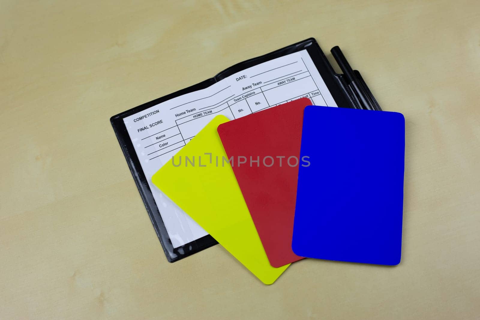 Football referee cards with new blue card lie in an open notebook to indicate player substitutions, changes in regulations