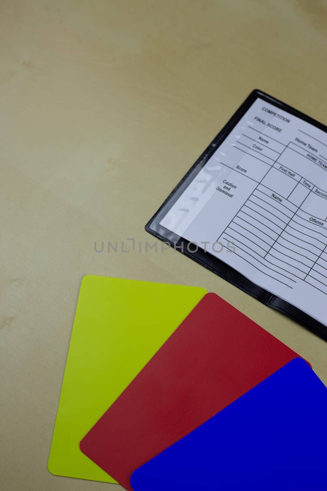 New set of football referee cards and notepad for substitutions lie on the table, introduction of an additional blue card in football to remove player for a while time