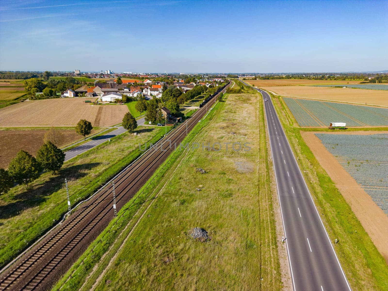 Railroad line and road in the countryside run parallel from drone shot by astrosoft