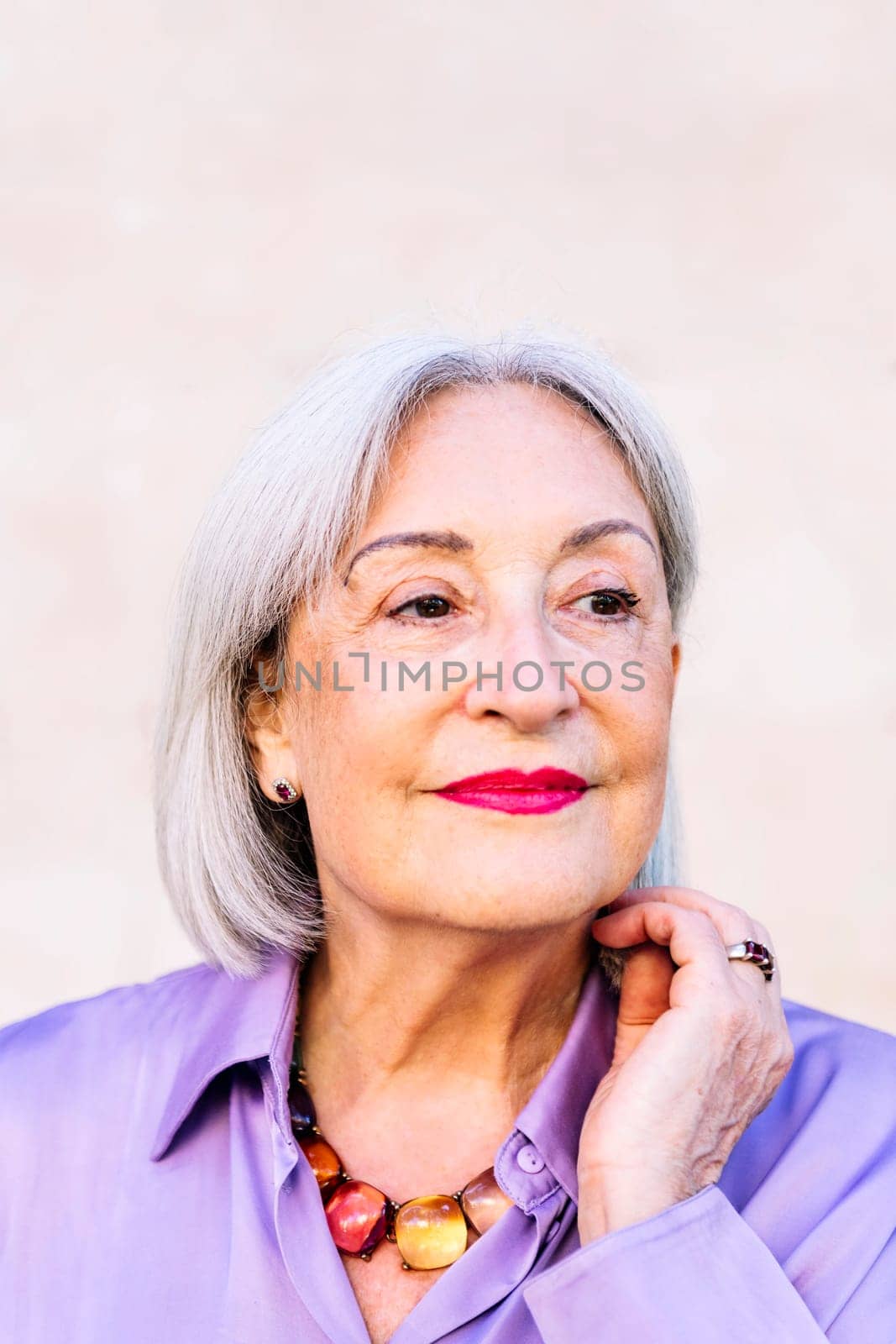 portrait of a beautiful smiling senior woman, concept of happiness of elderly people and active lifestyle, copy space for text
