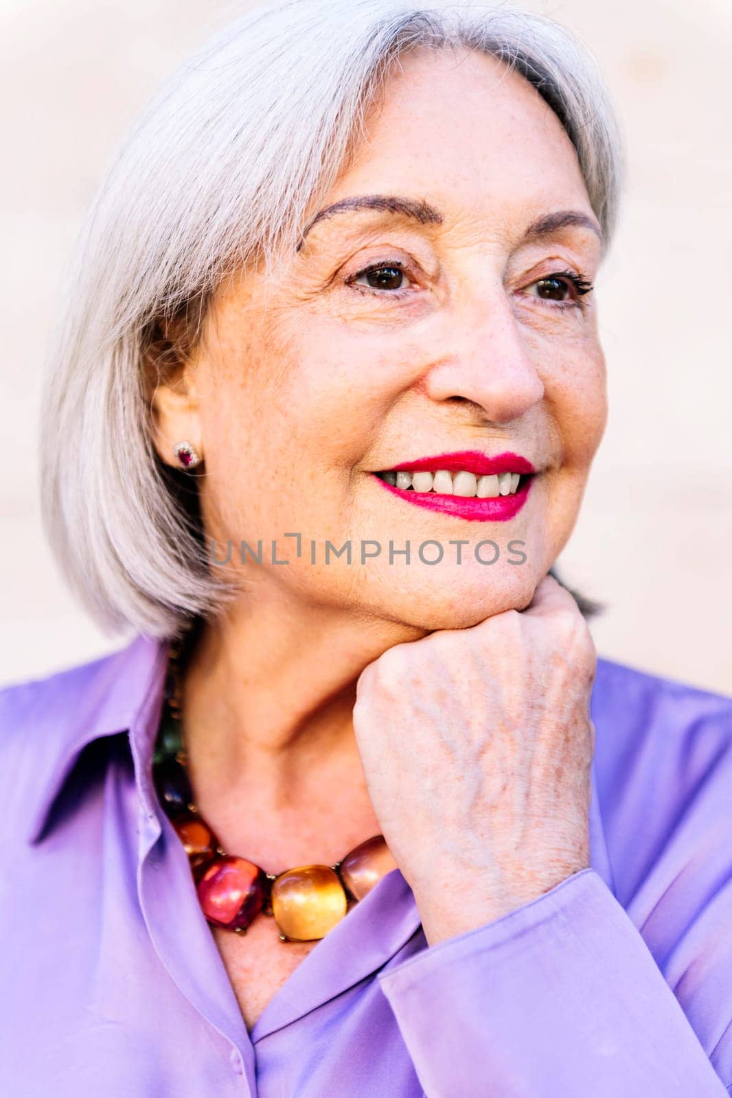 close up portrait of a beautiful smiling senior woman, concept of happiness of elderly people and active lifestyle