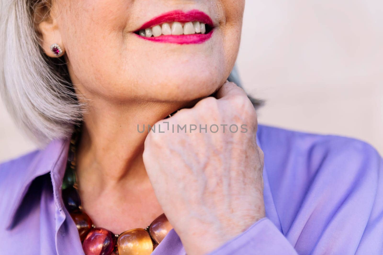 close up of an unrecognizable smiling senior woman, concept of happiness of elderly people and active lifestyle