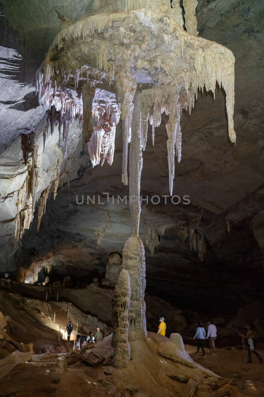 Explorers discover a vast cave filled with striking stalactites and stalagmites.
