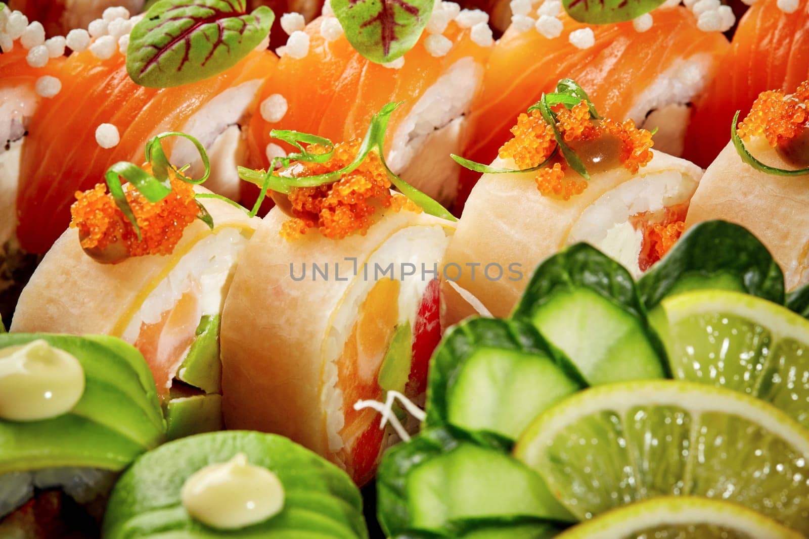 Vibrant assorted sushi rolls with salmon, avocado, mamenori, tobiko by nazarovsergey