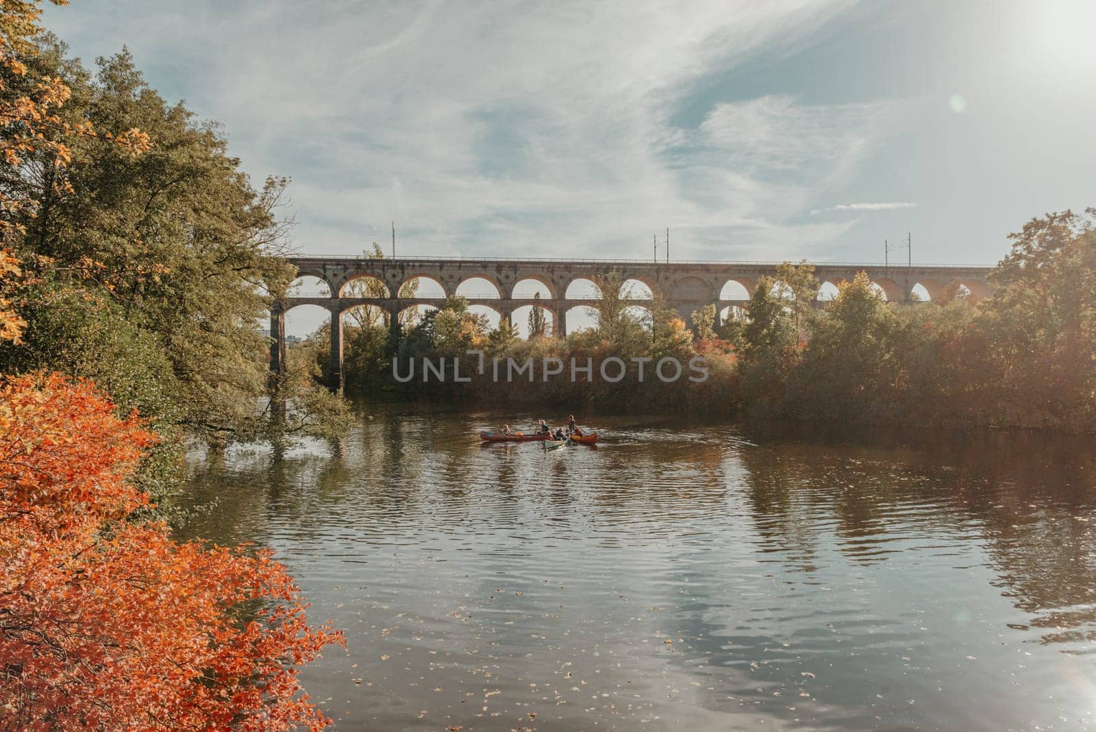 Railway Bridge with river in Bietigheim-Bissingen, Germany. Autumn. Railway viaduct over the Enz River, built in 1853 by Karl von Etzel on a sunny summer day. Bietigheim-Bissingen, Germany. Old viaduct in Bietigheim reflected in the river. Baden-Wurttemberg, Germany. Train passing a train bridge on a cloudy day in Germany by Andrii_Ko