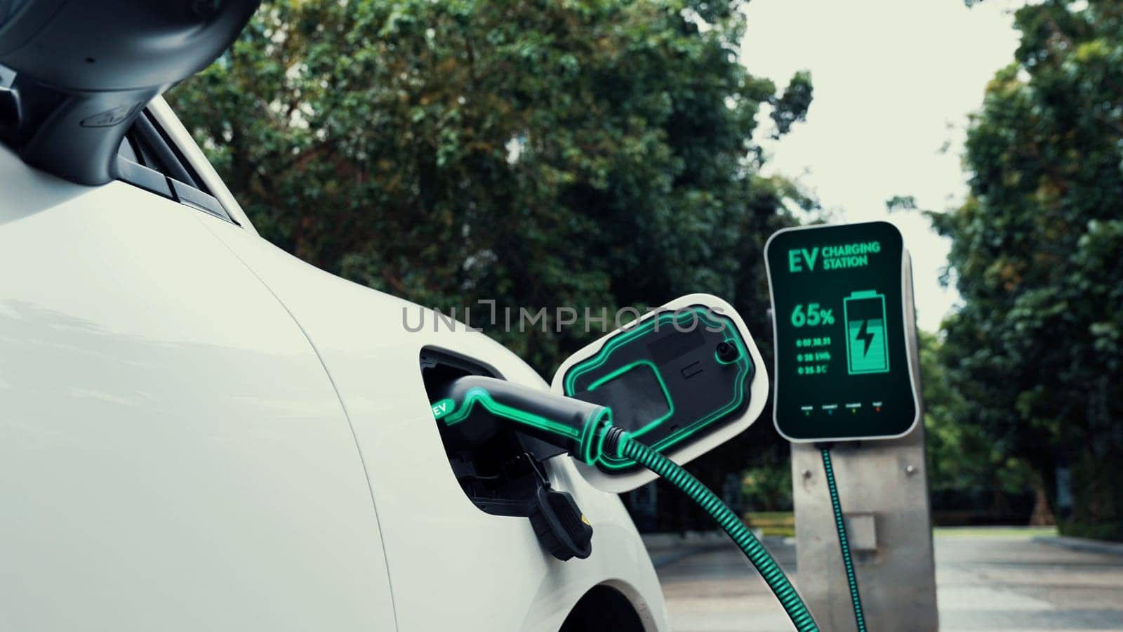 Electric car plugged in with charging station in eco green park. Peruse by biancoblue