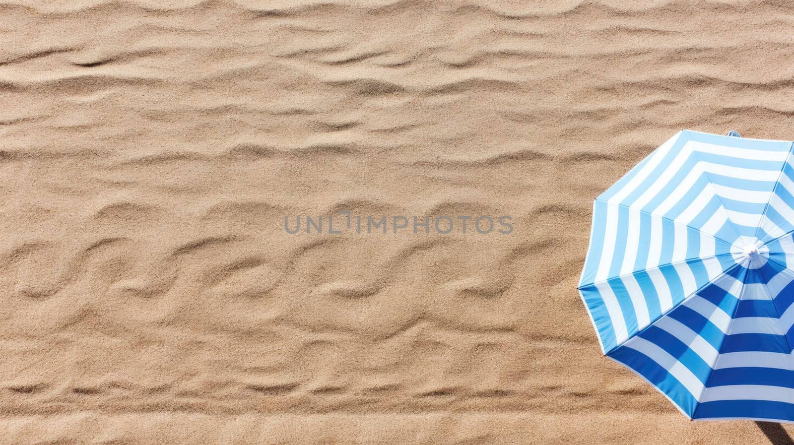 The concept of summer vacation. Top view on an umbrella on the sandy beach by natali_brill