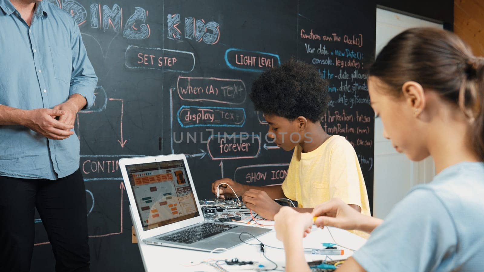 Happy caucasian teacher clap hands to applause student to encourage coding or programing prompt. Diverse student clapping hands to celebrate successful project while attend in STEM class. Edification.