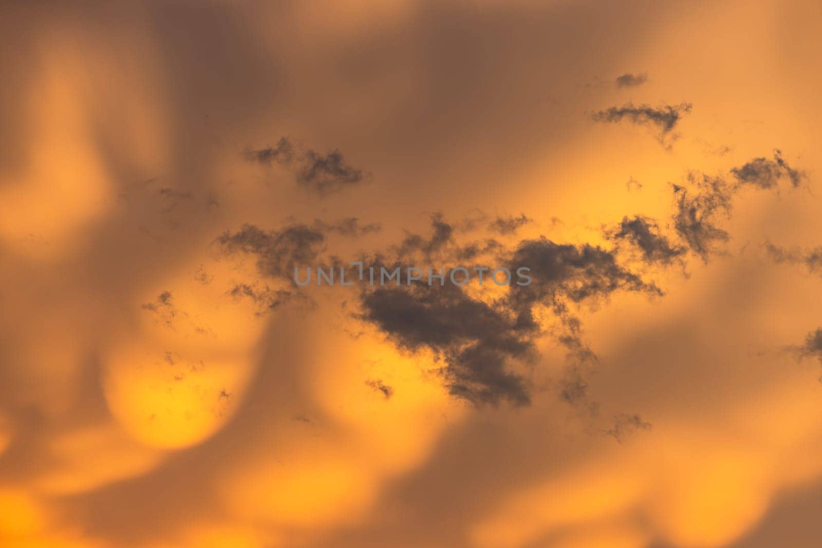 Spectacular weather with dramatic yellow clouds during a thunderstorm at sunset