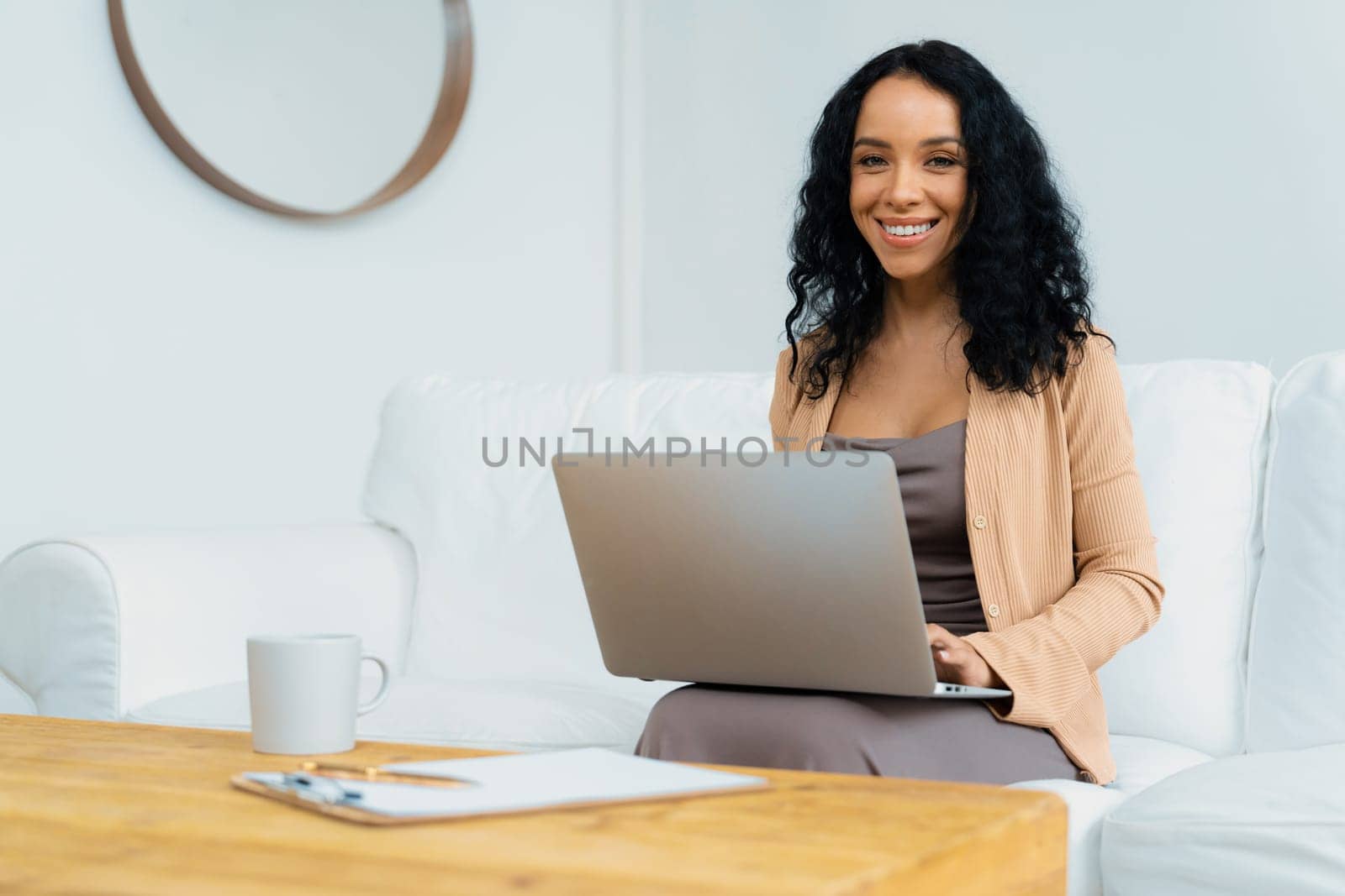 African-American woman using laptop computer for crucial work by biancoblue