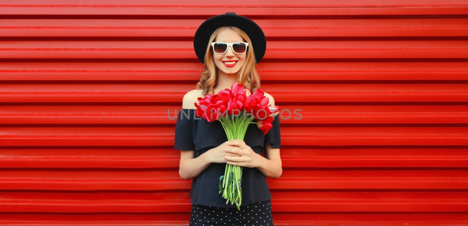 Beautiful happy smiling woman with bouquet of red rose flowers by Rohappy