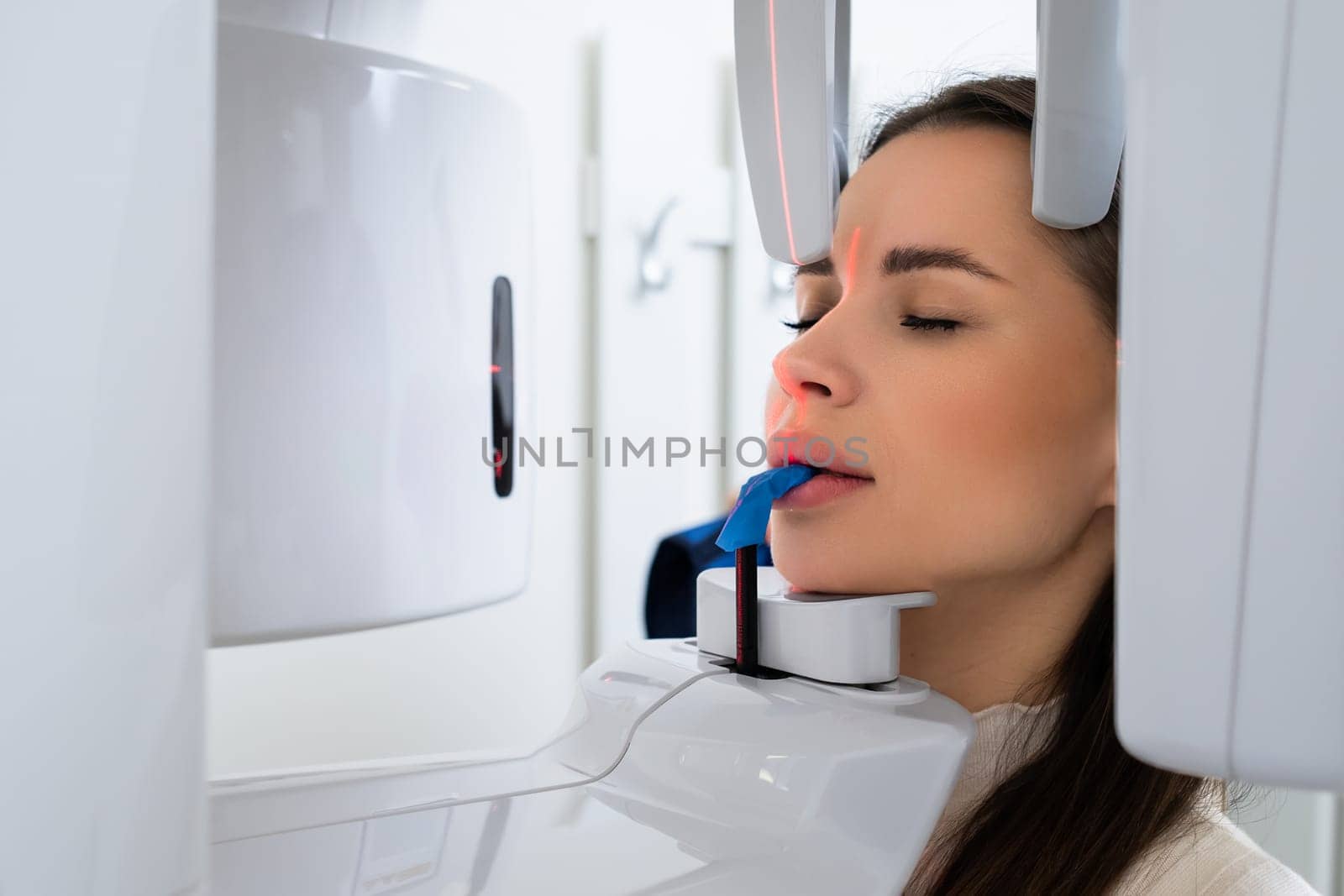 Portrait young woman having panoramic digital X ray of her teeth in dentist office. by vladimka