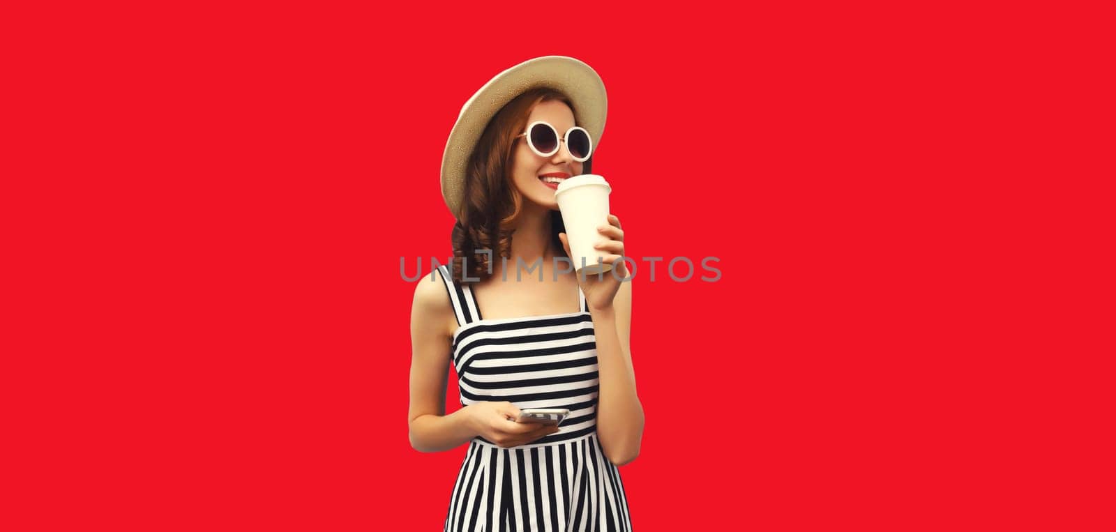 Happy smiling young woman drinking fresh juice or coffee and looking away by Rohappy