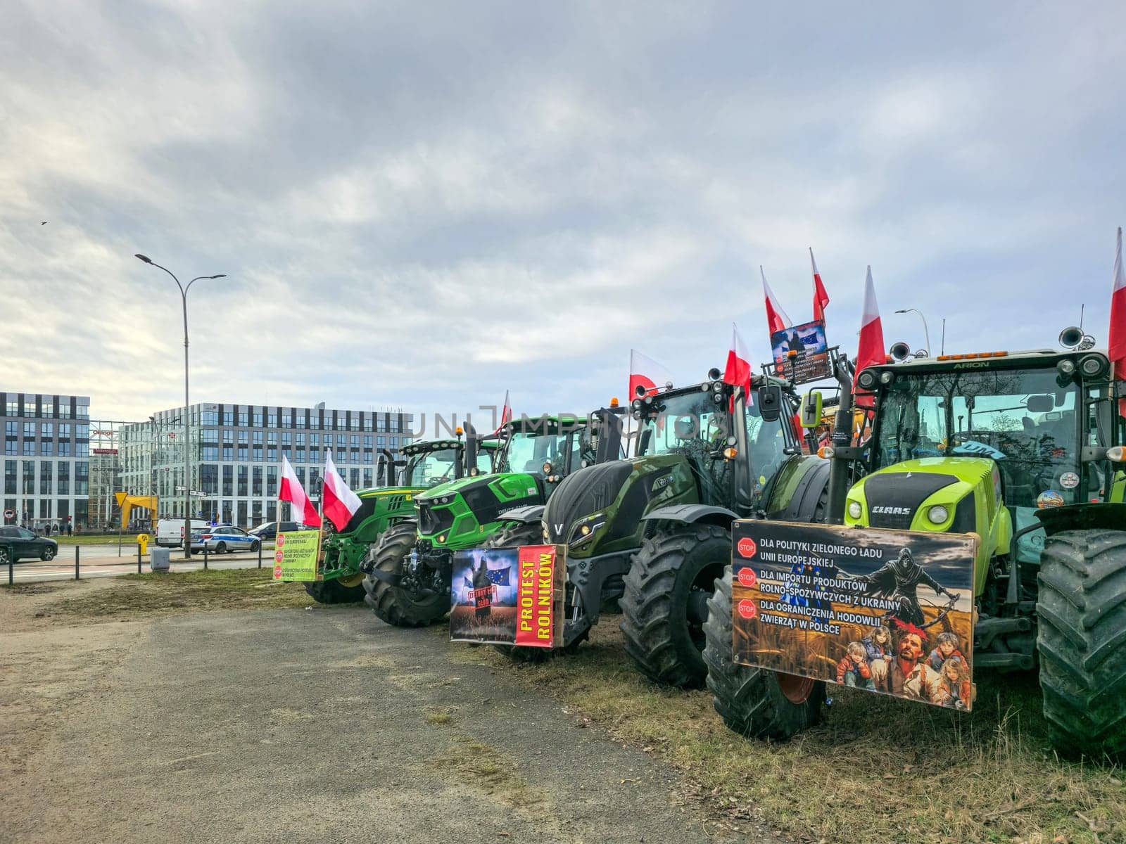 Wroclaw, Poland, February 15, 2024: Farmers protest against the European Union's anti-agricultural policies. Several farm tractors are parked in front of office buildings under a cloudy sky